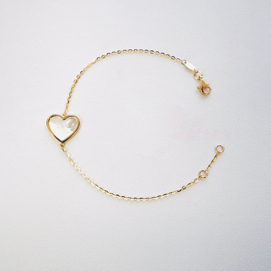 Fall in love with timeless elegance. Handcrafted in Italy from genuine 14K yellow gold, this dainty heart bracelet features a delicate heart charm with the famous mother of pearl—a symbol of love, purity, and refined beauty. Lightweight and effortlessly chic, it’s the perfect everyday luxury piece that layers beautifully or stands stunningly on its own.
Bracelet measures 7 inches long 
Weighs 2 grams 
Made in Italy.
All orders ship within 24 hours!
FREE leatherette jewelry box!