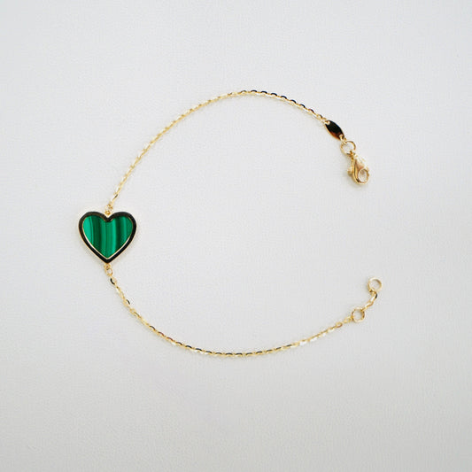 Fall in love with timeless elegance. Handcrafted in Italy from genuine 14K yellow gold, this dainty heart bracelet features a delicate heart charm with the famous malachite stone. Lightweight and effortlessly chic, it’s the perfect everyday luxury piece that layers beautifully or stands stunningly on its own.
The bracelet measures 7 inches long 
Weighs 2 grams 
Made in Italy.
All orders ship within 24 hours!
FREE leatherette jewelry box!
FREE USPS Priority Mail shipping!