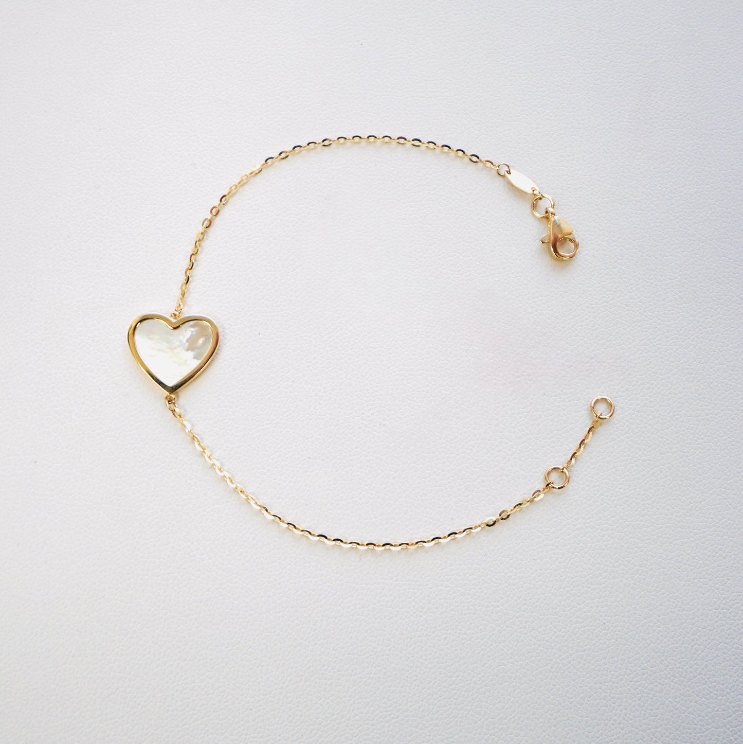 Fall in love with timeless elegance. Handcrafted in Italy from genuine 14K yellow gold, this dainty heart bracelet features a delicate heart charm with the famous&nbsp;mother of pearl—a symbol of love, purity, and refined beauty. Lightweight and effortlessly chic, it’s the perfect everyday luxury piece that layers beautifully or stands stunningly on its own.

Bracelet measures 7 inches long&nbsp;

Weighs 2 grams&nbsp;

Made in Italy.
All orders ship within 24 hours!
FREE leatherette jewelry box!
