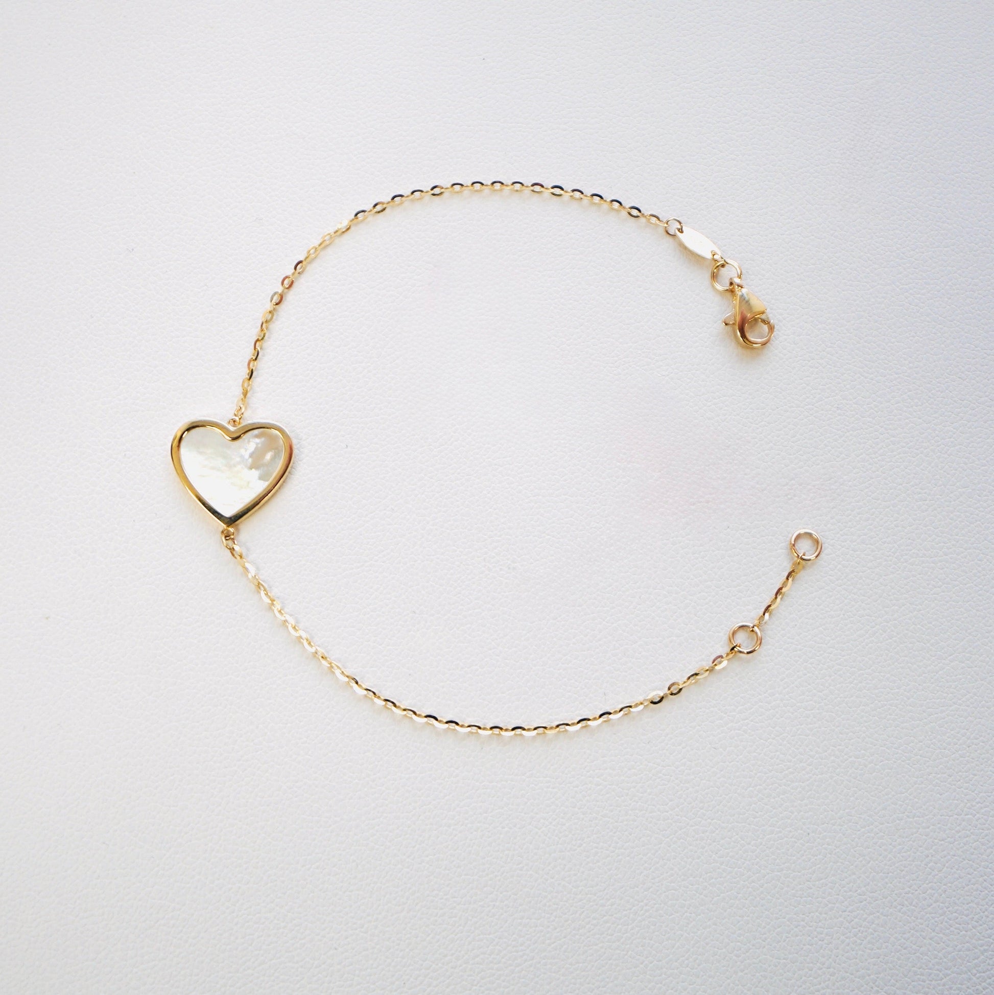 Fall in love with timeless elegance. Handcrafted in Italy from genuine 14K yellow gold, this dainty heart bracelet features a delicate heart charm with the famous&nbsp;mother of pearl—a symbol of love, purity, and refined beauty. Lightweight and effortlessly chic, it’s the perfect everyday luxury piece that layers beautifully or stands stunningly on its own.

Bracelet measures 7 inches long&nbsp;

Weighs 2 grams&nbsp;

Made in Italy.
All orders ship within 24 hours!
FREE leatherette jewelry box!
