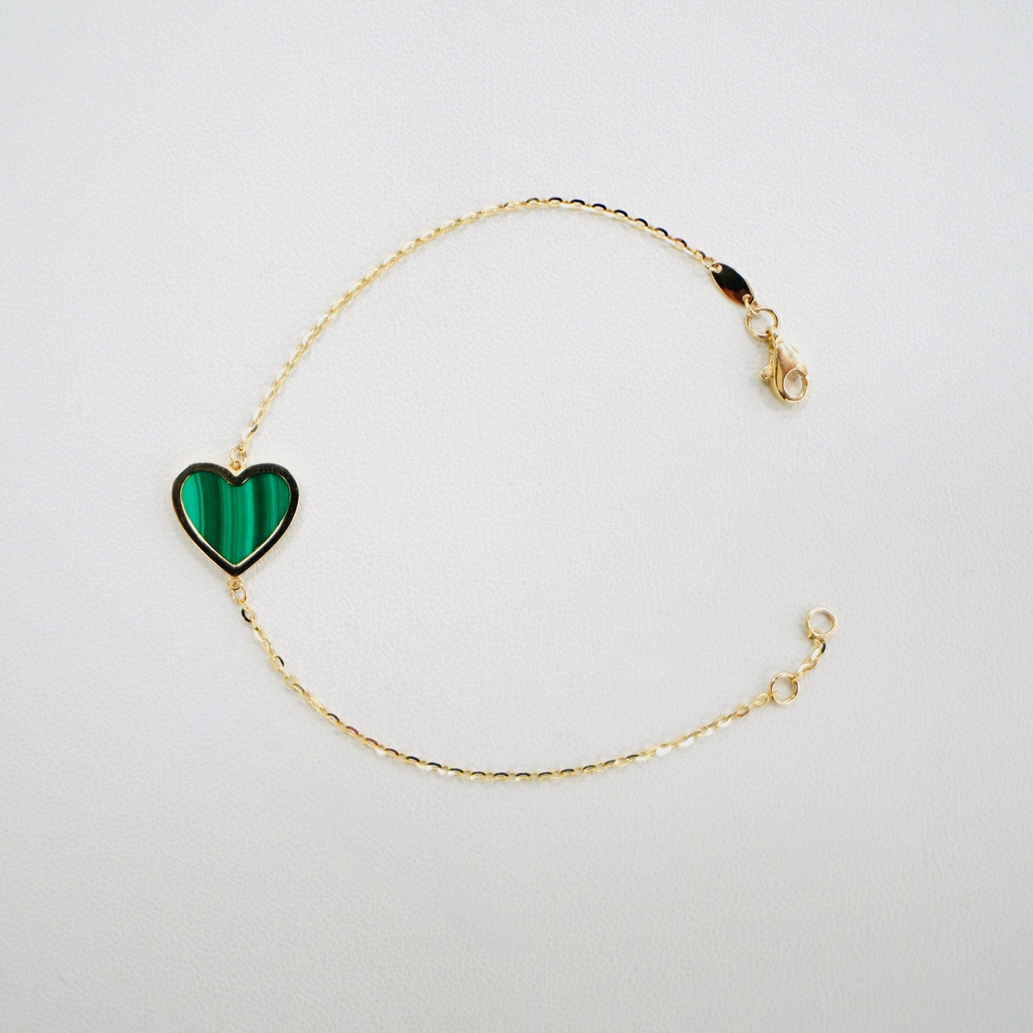 Fall in love with timeless elegance. Handcrafted in Italy from genuine 14K yellow gold, this dainty heart bracelet features a delicate heart charm with the famous malachite stone. Lightweight and effortlessly chic, it’s the perfect everyday luxury piece that layers beautifully or stands stunningly on its own.

The bracelet measures 7 inches long&nbsp;

Weighs 2 grams&nbsp;

Made in Italy.
All orders ship within 24 hours!
FREE leatherette jewelry box!
FREE USPS Priority Mail shipping!
