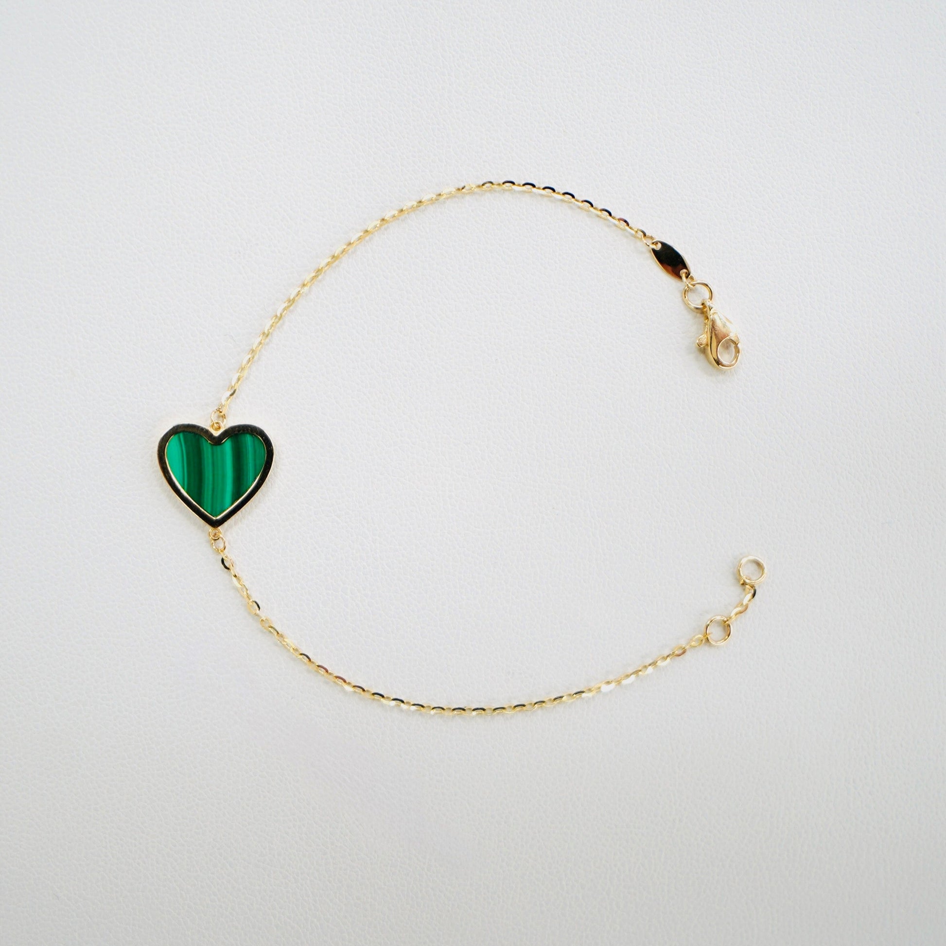 Fall in love with timeless elegance. Handcrafted in Italy from genuine 14K yellow gold, this dainty heart bracelet features a delicate heart charm with the famous malachite stone. Lightweight and effortlessly chic, it’s the perfect everyday luxury piece that layers beautifully or stands stunningly on its own.

The bracelet measures 7 inches long&nbsp;

Weighs 2 grams&nbsp;

Made in Italy.
All orders ship within 24 hours!
FREE leatherette jewelry box!
FREE USPS Priority Mail shipping!