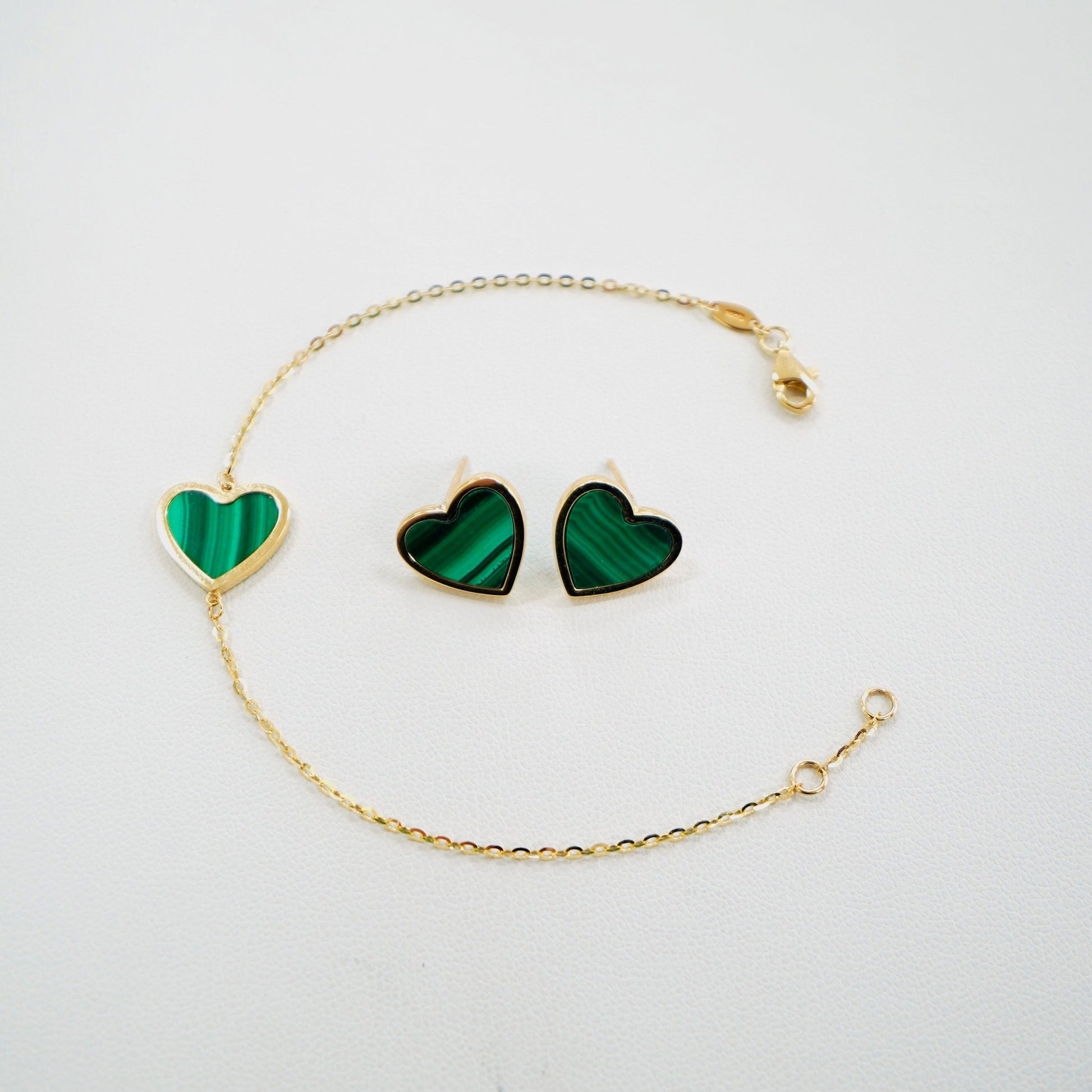 Fall in love with timeless elegance. Handcrafted in Italy from genuine 14K yellow gold, this dainty heart bracelet and earrings feature a delicate heart charm with the famous malachite stone. Lightweight and effortlessly chic, it’s the perfect everyday luxury piece that layers beautifully or stands stunningly on its own.&nbsp;

The bracelet measures 7 inches long

The bracelet and earrings weigh 4.5 grams&nbsp;

Made in Italy.
All orders ship within 24 hours!
FREE leatherette jewelry box!
FREE USPS Priority